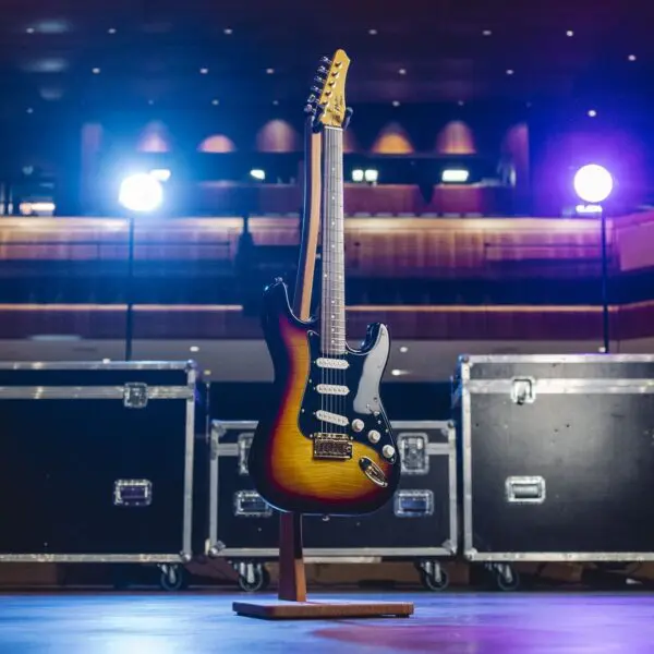 The Atlanta, Guitar Collection, Limited Series is showcased on a stand under stage lights at Montreux Jazz Guitar Atlanta, with two large black equipment cases in the background.